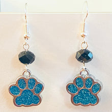 Load image into Gallery viewer, Paw Print sports fan earrings: light blue glitter paw print with black bead