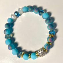 Load image into Gallery viewer, Blue Skies - Light blue iridescent ceramic beads with dark teal blue crystals, gold disc spacers, and white crystal pavé bead