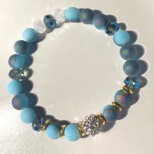 Load image into Gallery viewer, Blue Skies - Light blue iridescent ceramic beads with dark teal blue crystals, gold disc spacers, and white crystal pavé bead