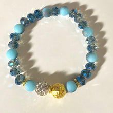 Load image into Gallery viewer, Blue Skies II - Light blue iridescent ceramic beads with dark teal blue crystals, gold disc spacers, and white crystal pavé bead
