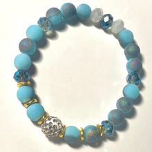 Load image into Gallery viewer, Blue Skies - Light blue iridescent ceramic beads with dark teal blue crystals, gold disc spacers, and white crystal pavé bead
