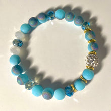 Load image into Gallery viewer, Blue Skies - Light blue iridescent ceramic beads with dark teal blue crystals, gold disc spacers, and white crystal pavé bead
