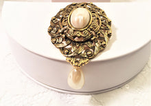 Load image into Gallery viewer, Vintage Avon ornate gold oval brooch / pendant w faux pearl cabochon and teardrop pearl dangle
