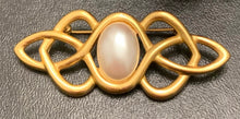 Load image into Gallery viewer, Vintage Anne Klein matte gold Celtic knotwork brooch with oval faux pearl cabochon

