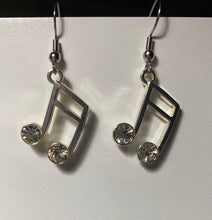 Load image into Gallery viewer, Silvertone music note earrings with rhinestones
